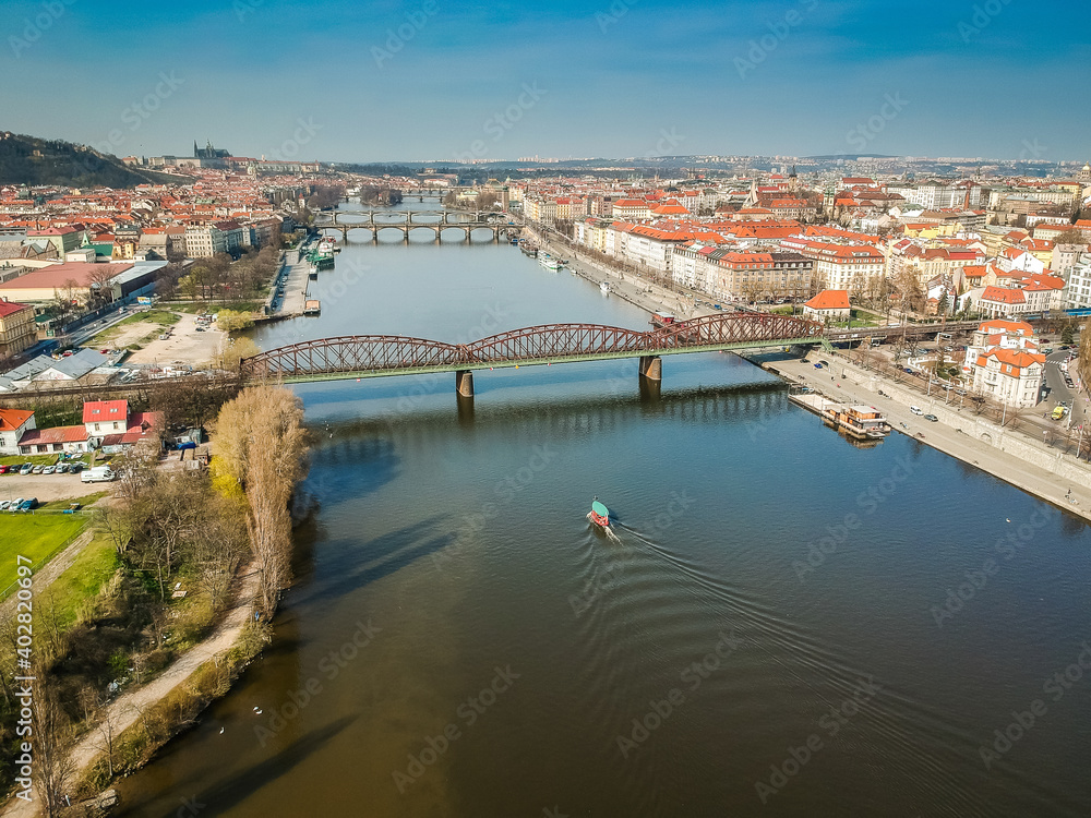 Railway bridge between Vyton and Smichov area above Moldau river with other bridges, Old Town and Prague Castle in background