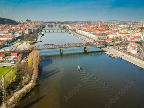 Railway bridge between Vyton and Smichov area above Moldau river with other bridges, Old Town and Prague Castle in background
