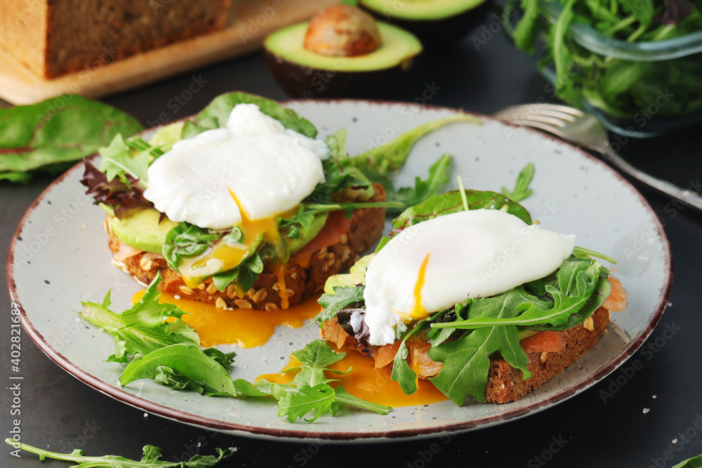 Homemade sandwiches with salmon, avocado and poached eggs Homemade sandwiches with salmon, avocado and poached eggs
