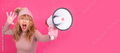 woman wearing warm clothes and megaphone isolated on background