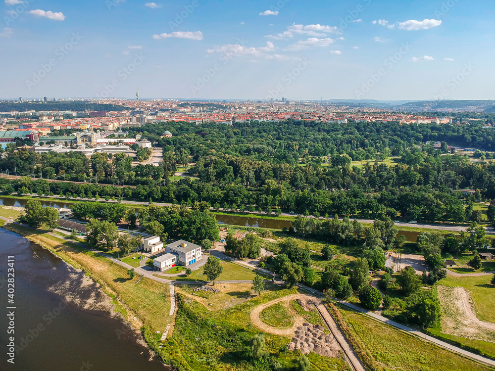 Aerial view of Stromovka park from river Vltava with urban part of Prague in background