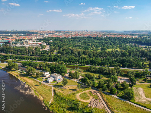 Aerial view of Stromovka park from river Vltava with urban part of Prague in background © marketanovakova