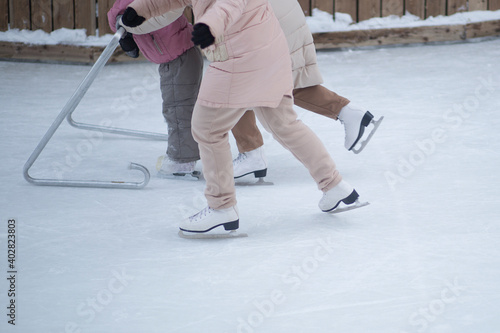 People skate in the winter in the cold on the ice rink.
