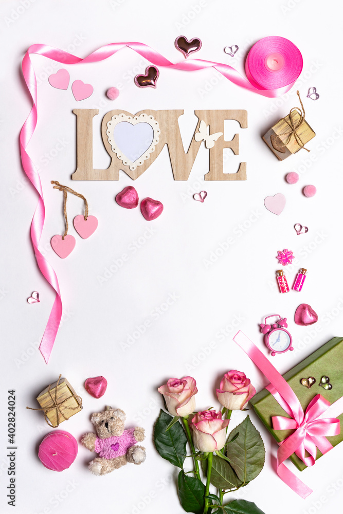 Happy Valentine's day. Roses flowers, LOVE text, hearts, gifts and decorative items in pink pastel colors on white background. Greeting card for Valentine's day, mockup. Flat lay, top view, copy space Happy Valentine's day. Roses flowers, LOVE text, hearts, gifts and decorative items in pink pastel colors on white background. Greeting card for Valentine's day, mockup. Flat lay, top view, copy space