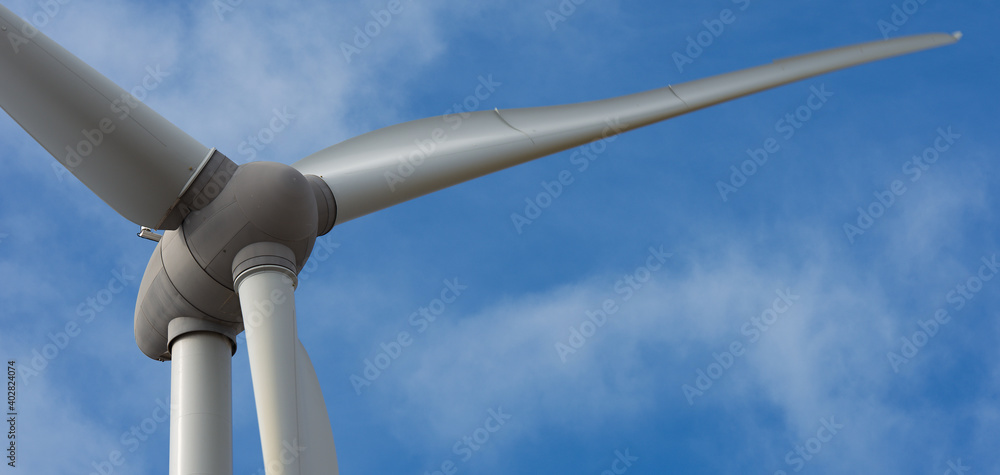Detail of wind turbine against blue sky, clean energy generator wind turbine in wind farm Detail of wind turbine against blue sky, clean energy generator wind turbine in wind farm