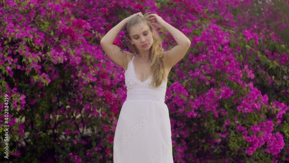 Charming young girl model with long blonde hair in a white dress Charming young girl model with long blonde hair in a white dress