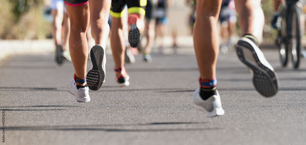 Marathon running race, runners feet on road, sport, fitness and healthy lifestyle concept