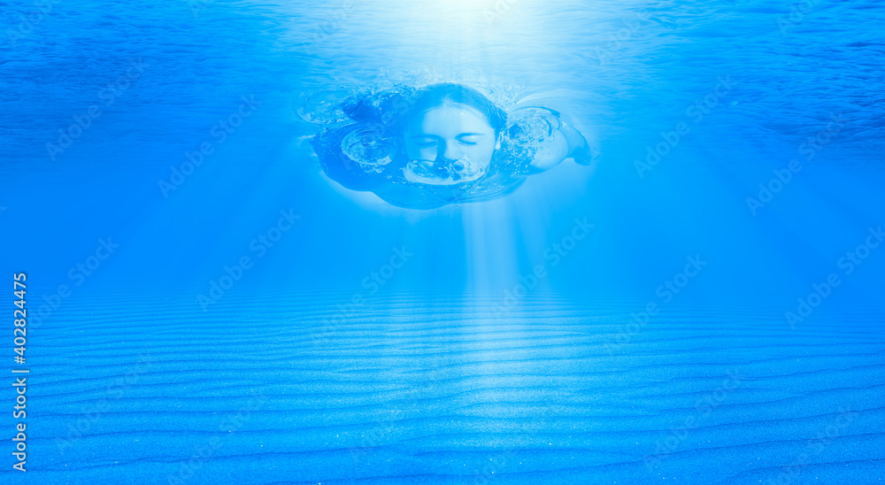 Obraz premium Girl swim underwater with sun rays
