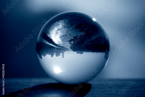 Glass ball with inverted street view. Lens ball photography. © Azazello