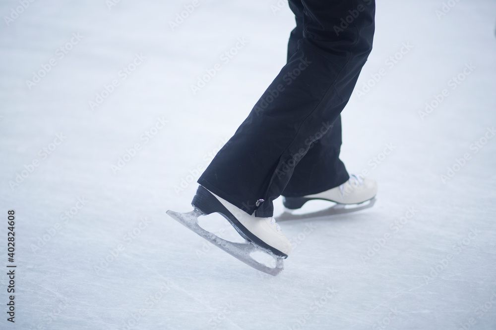 People skate in the winter in the cold on the ice rink. People skate in the winter in the cold on the ice rink.