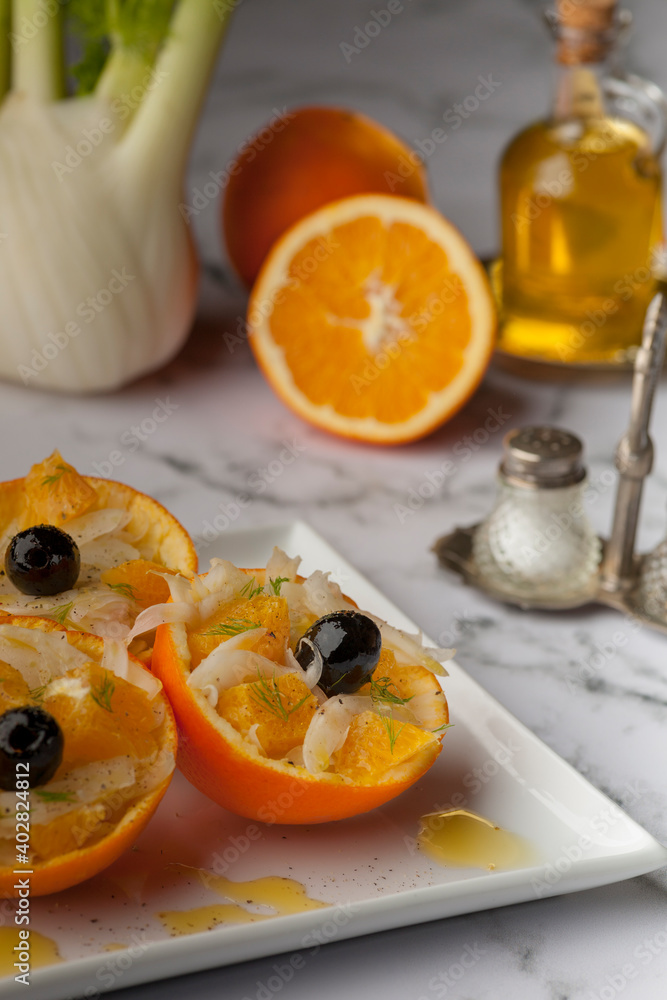 Fennel salad with orange and olives on a white backgrou d