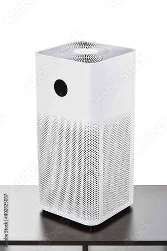 Air purifier with filter for cleaning fine dust PM2.5 odors and smoke isolated on white background with clipping path, standing on a dark table