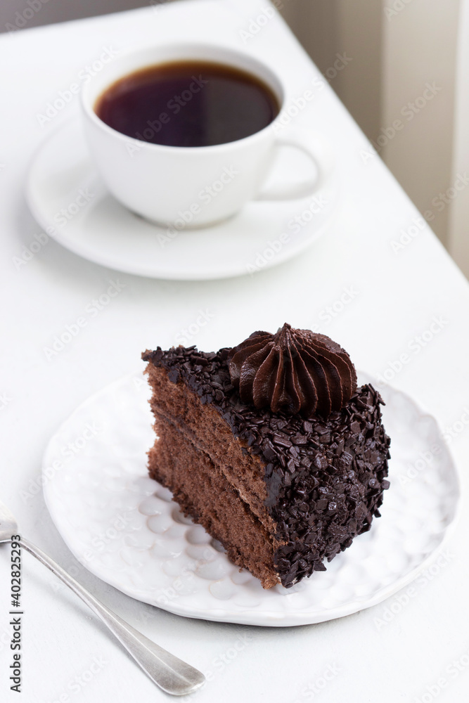 Chocolate cake and coffee, still life in a light interior. Chocolate cake and coffee, still life in a light interior.