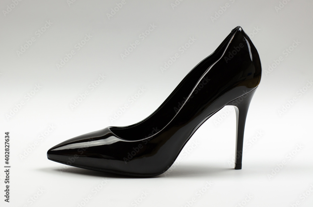 Black patent women's shoes on a gray background. Women's stiletto heels Black patent women's shoes on a gray background. Women's stiletto heels