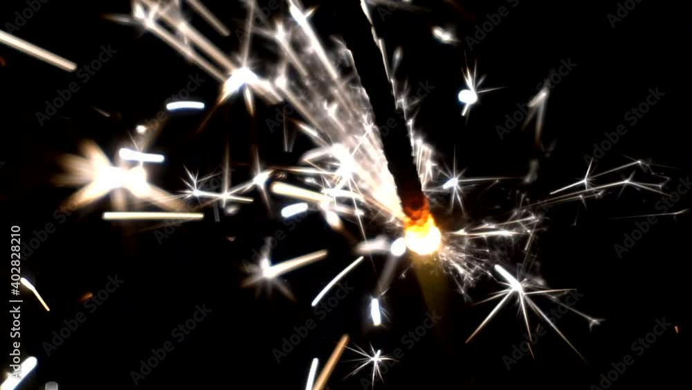 Bengal candle burns in the dark with a bright flame with sparks. Bengal candle burns in the dark with a bright flame with sparks.