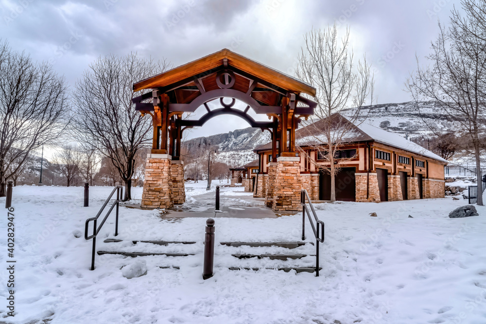 Steps leading to pavilion and building amid snowy nature scenery in winter Steps leading to pavilion and building amid snowy nature scenery in winter