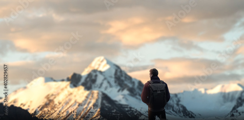 alone men on winter mountain admiring natural beauty.