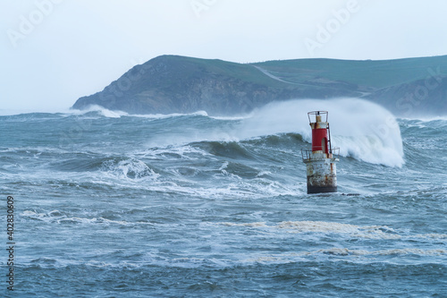 Swell in the Cantabrian Sea in the area of the Buoy Lighthouse of La Barra de San Vicente de la Barquera, at the mouth of the port. Oyambre Natural Park, Cantabria, Spain, Europe