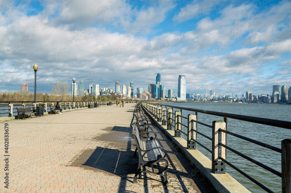 Jersey City, NJ - USA - Jan 2, 2021: a view of Downtown Jersey City seen from the Liberty Walkway, a promenade, stretching from the CRRNJ Terminal along the waterfront to the Statue of Liberty.