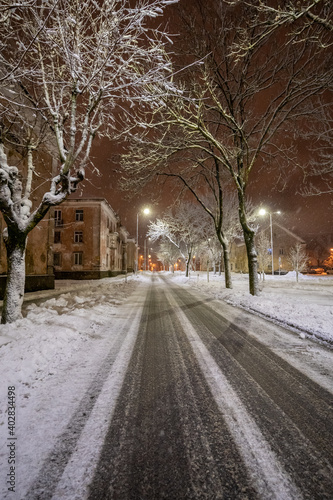 Cold winter night. Winter urban landscape. Snowfall. © nikwaller