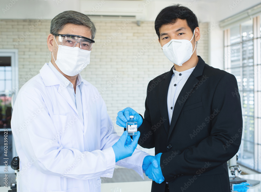 Businessman and doctor shaking hand's for agreement covid19 vaccine in hand. Businessman and doctor shaking hand's for agreement covid19 vaccine in hand.