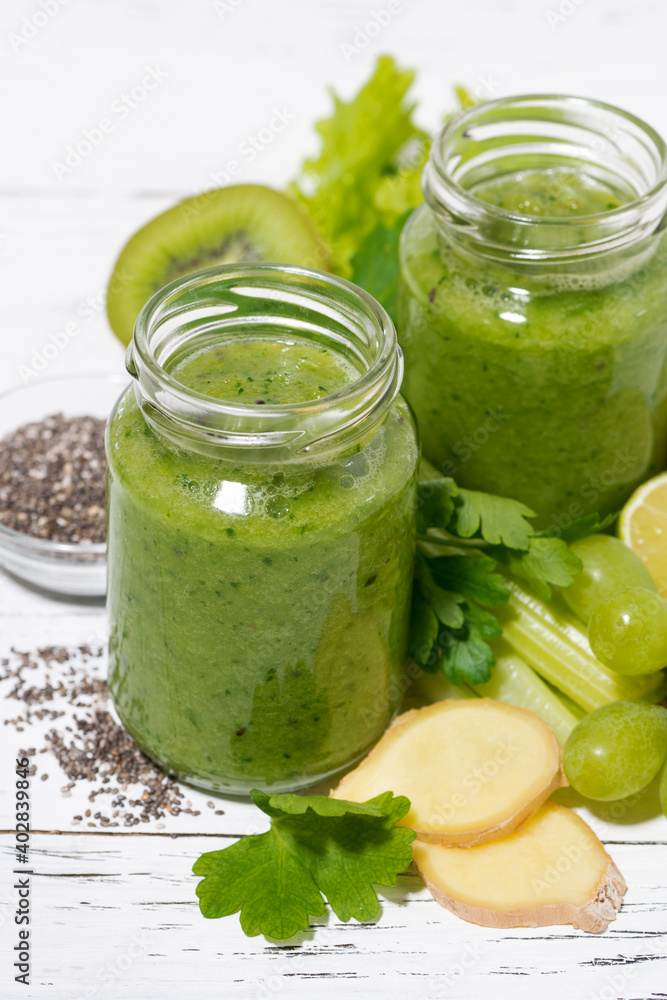 green fruit and vegetable smoothies in jars, vertical top view green fruit and vegetable smoothies in jars, vertical top view