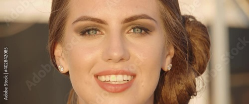 Close up of charming beautiful face of young woman with amazing expressive eyes and smile