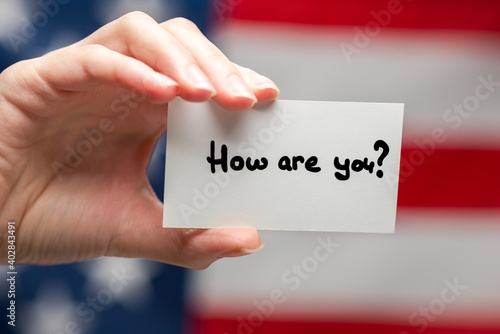 How are you text on a card. American flag background.