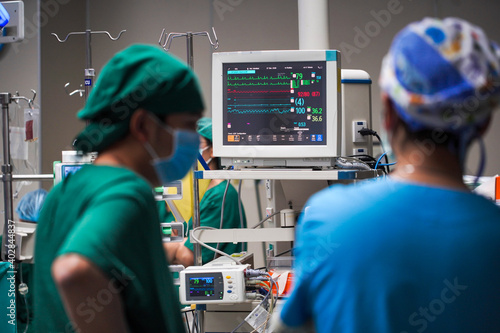 Vital signs monitor with machines during surgery on a patient in operating room.
