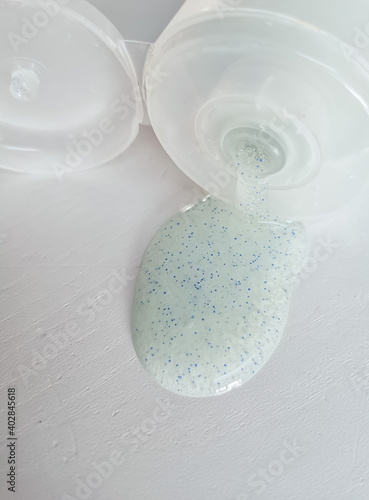 Micro plastic particles in a face scrub on a white background.