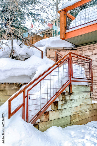 Outdoor stairs of hill home covered with thick layer of snow in winter