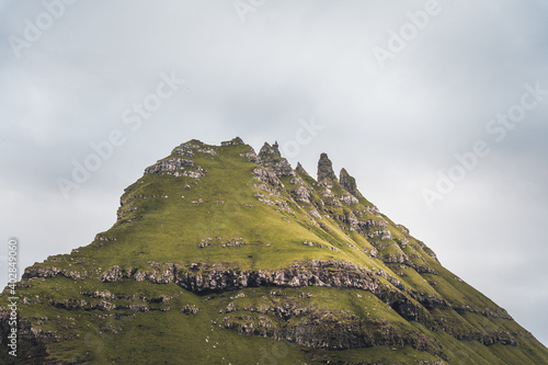 Top view vertical composition with the iconic Drangarnir gate, Tindholmur and mykines island in the background, Faroe Islands