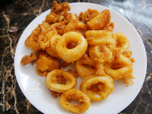 Squid cut into small pieces and fried with flour. The flour has been mixed with eggs to add flavour and to make it crisper.