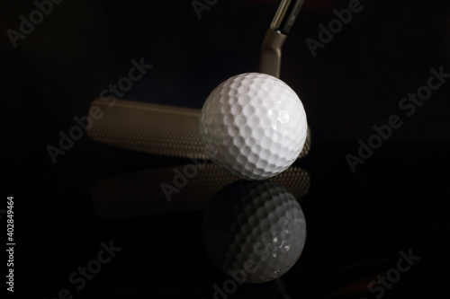 Golf balls and golf clubs to dark Background