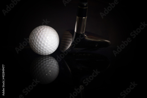 Golf balls and golf clubs to dark Background