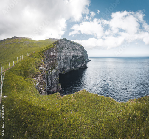 Faroe islands village of Gjogv or Gjov in Danish. Sea-filled gorge on the northeast tip of the island of Eysturoy, in the Faroe Islands. photo