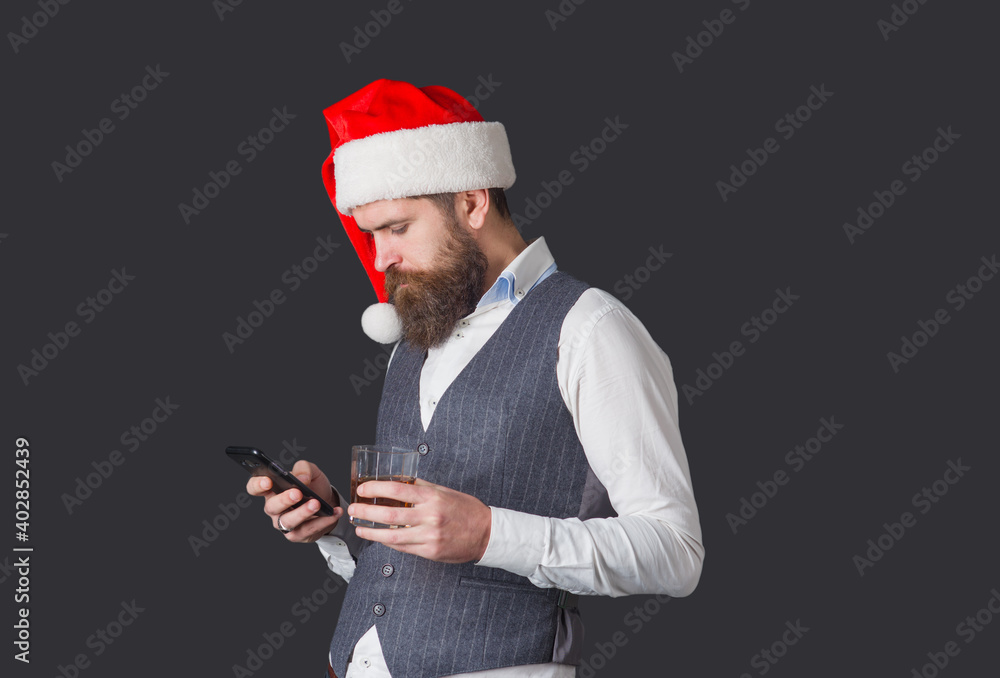 Christmas bearded man with smartphone dependence. Online celebrating. Phone dependency male. Christmas bearded man with smartphone dependence. Online celebrating. Phone dependency male.