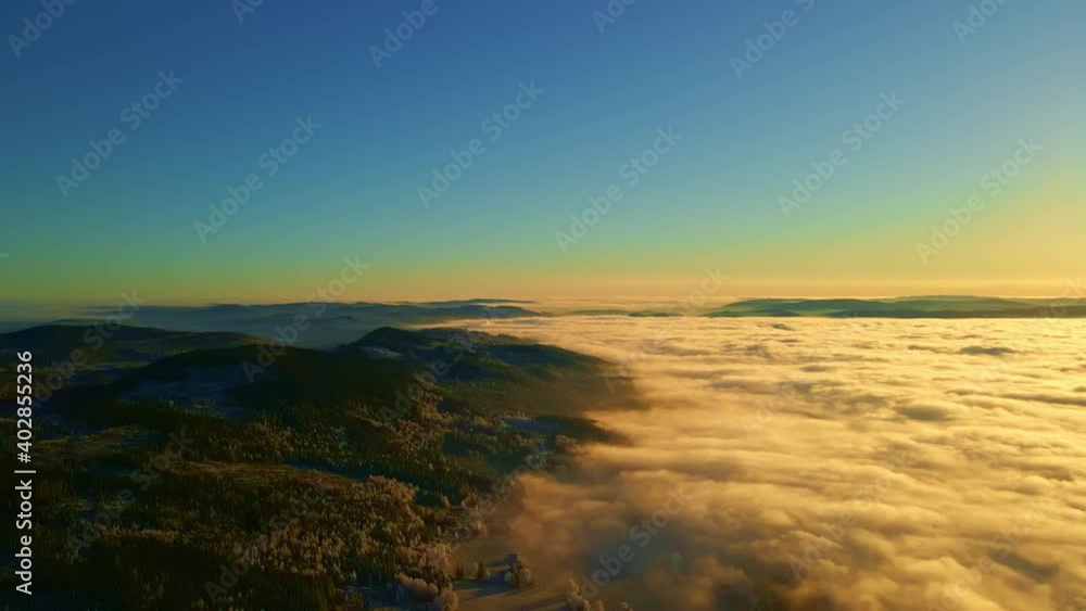Flying high above a forest valley with dense fog, and a warm sunset. Flying high above a forest valley with dense fog, and a warm sunset.