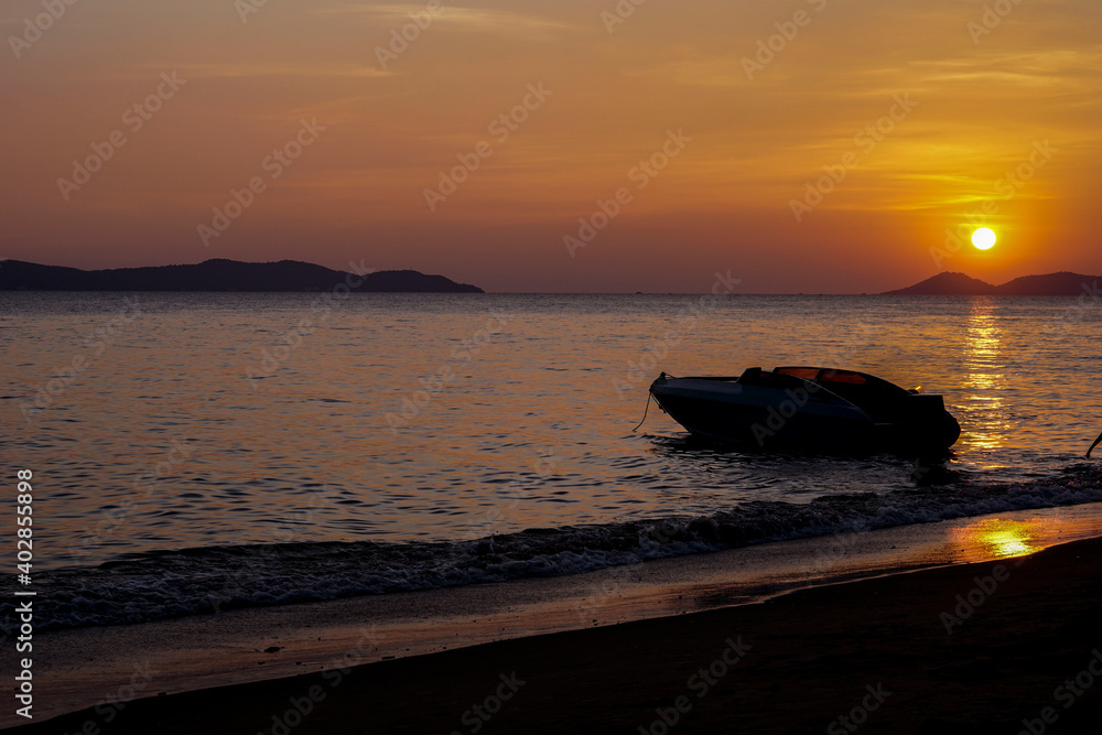 The boat in the sea and the sun is setting The boat in the sea and the sun is setting