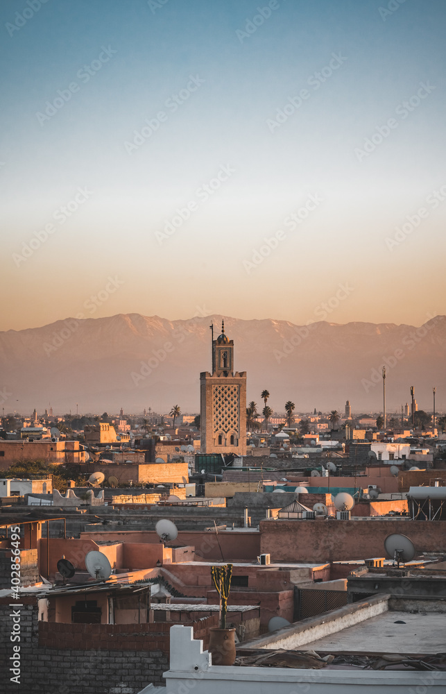 Sunset view of Koutoubia mosque in Marrakesh, Morocco. Panoramic view of Marrakech with the old part of town Medina and minaret. Travel photo concept in summer.