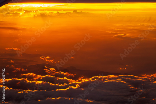 Dramatic sunset sky with clouds. Skyscraper background view seen from the plane. © pjjaruwan