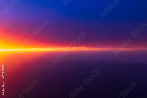 Dramatic sunset sky with clouds. Skyscraper background view seen from the plane.