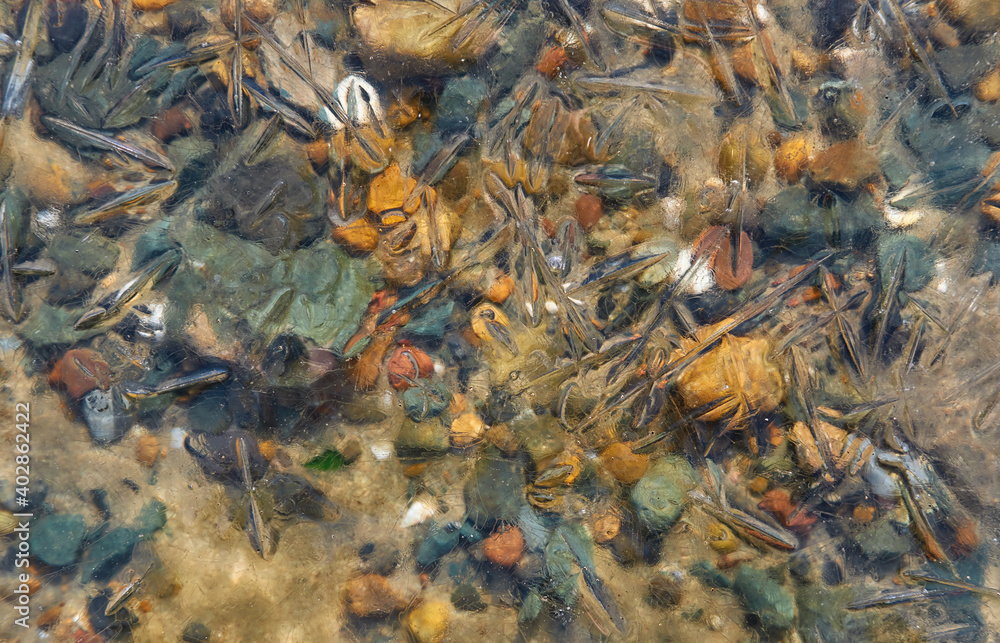Pebble stones in water under ice. Pebble stones in water under ice.