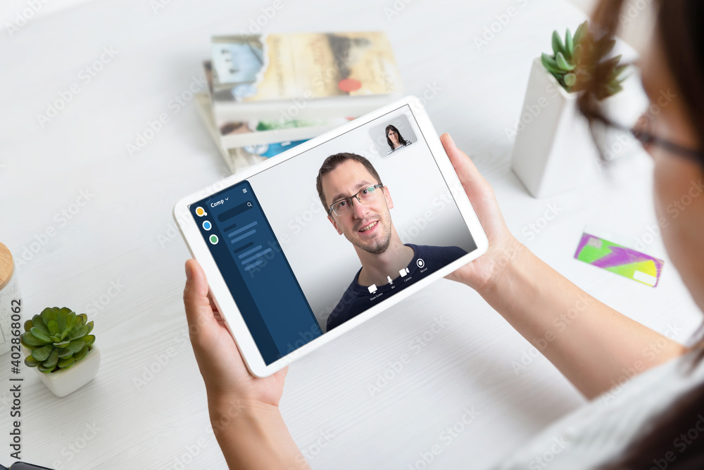 Online conference concept. Woman using tablet to make video call with business partner.