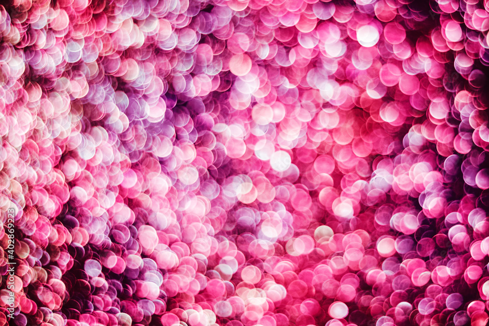 Obraz premium Bokeh background. Glitter texture. Vibrant pink glowing stars. Shiny magic backdrop. Glamour background for graphic design. Colorful confetti texture. Futuristic bokeh background.