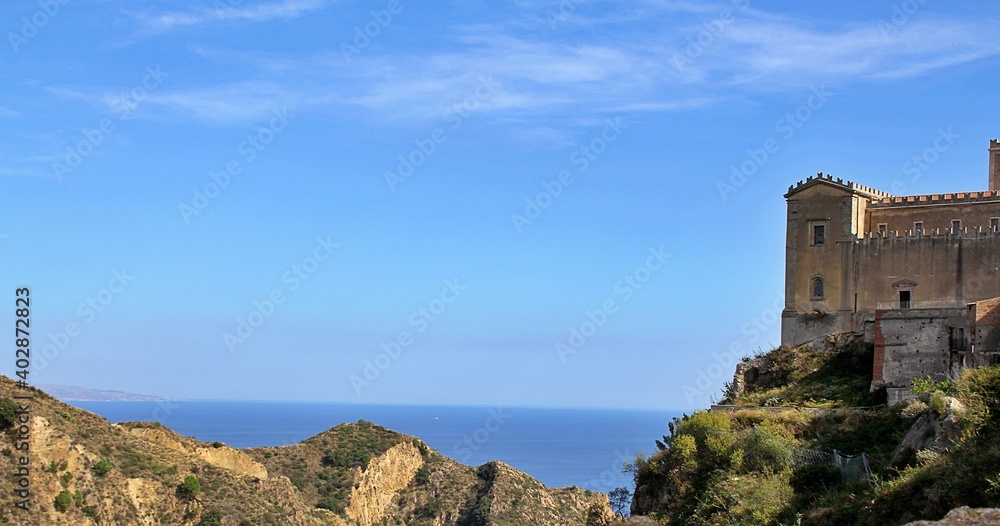 at the top of the mountain, church, around the hill and in the distance a view of the sea, Italy, Sicily, Savoca