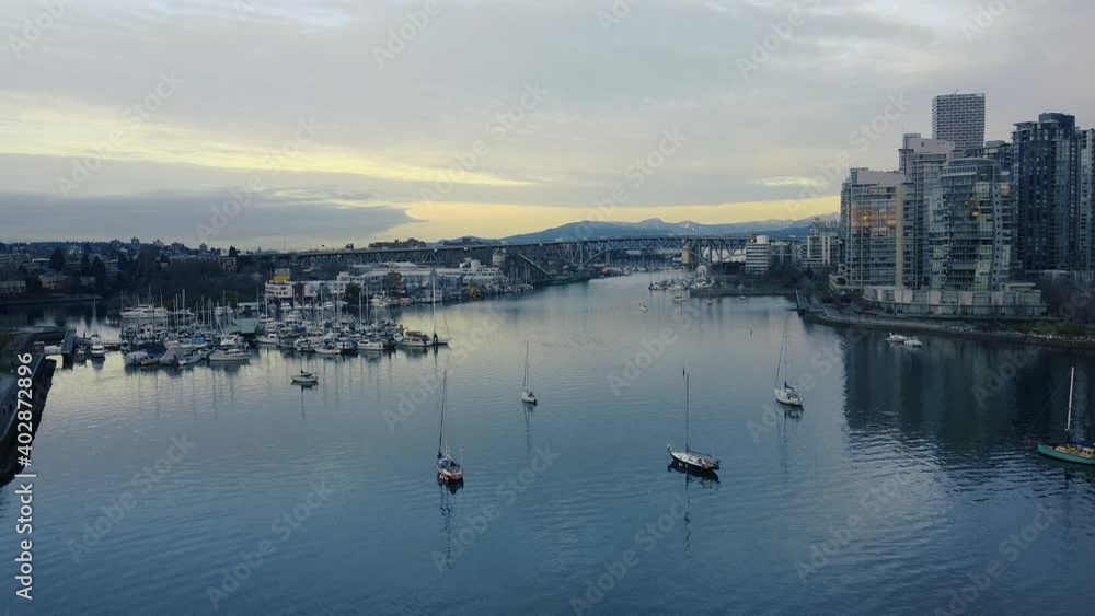Fly over False creek with moored yachts in Vancouver on a sunny morning Fly over False creek with moored yachts in Vancouver on a sunny morning
