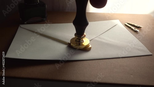 Slow-motion of stamping wax for sealing a secure letter. Concept of secret conversation sends in the past. The 18th-century technique of mailing. Medieval way to send encrypted secured messages. photo
