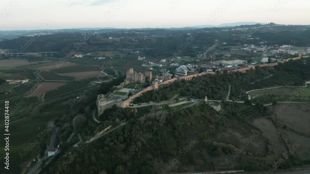Old Obidos Castle overlooking the green lands of Leiria, Portugal - Aerial Old Obidos Castle overlooking the green lands of Leiria, Portugal - Aerial