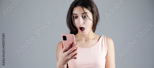 The surprised woman holding phone